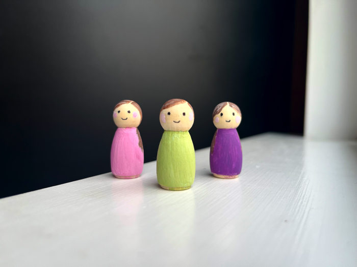 Finished painted peg dolls.