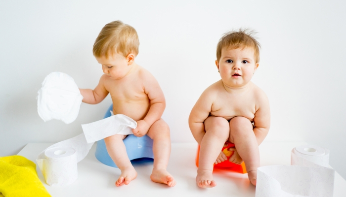 Baby sitting on a potty.