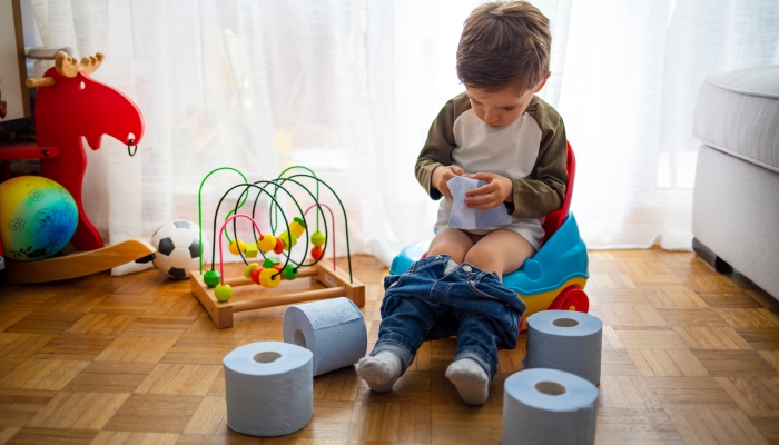 Kid playing with educational toy & Toilet training concept.