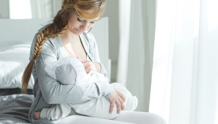 Mom nursing baby during daytime.