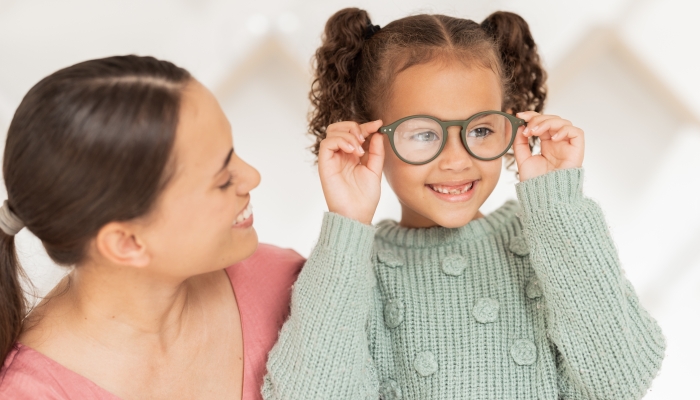 Optometry, vision and mother with child with glasses after examination, test and diagnosis for eyesight.