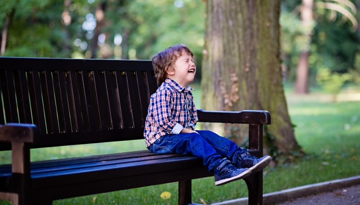 Toddler having tantrum in the park.