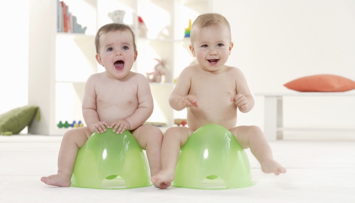 Two babies in a potty training.