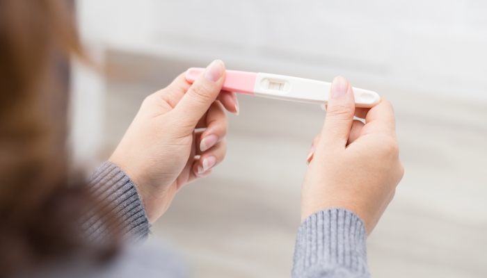 Woman holding pregnancy test, New life and new family concept.