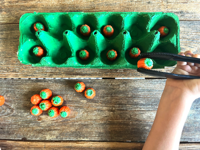 Pumpkin picking with tongs.