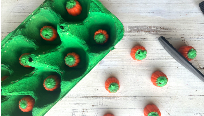 Pumpkin picking fine motor activity.