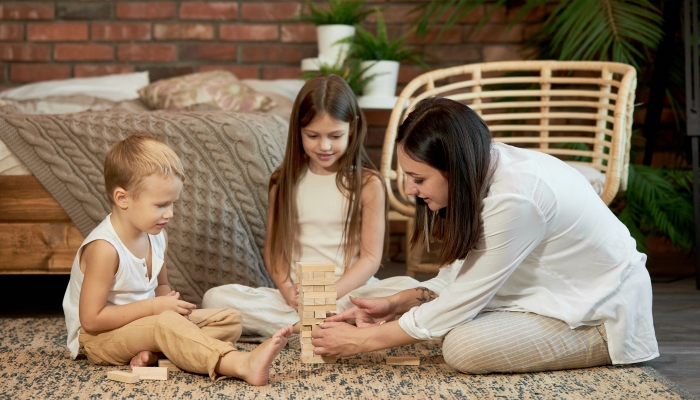 Mom and kids play squirl tower.