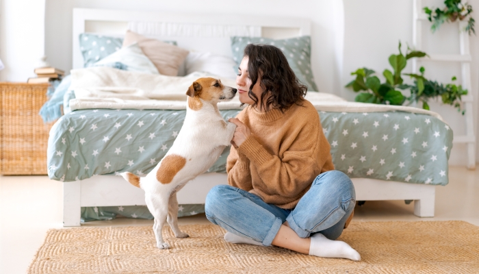 Loving family with a puppy in the bedroom.