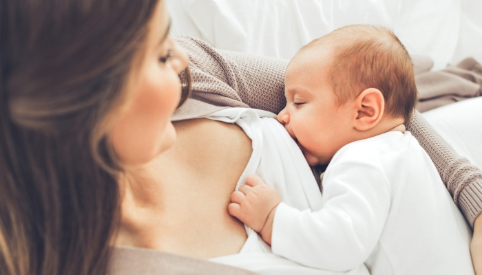 A woman is breastfeeding a baby.