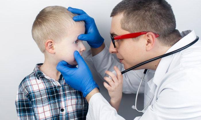 An ophthalmologist examines a boy who complains of burning and pain in his eyes.