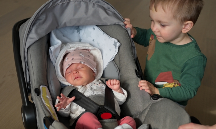 Cute little toddler and his newborn baby sister.