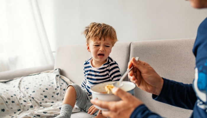 Unhappy child refusing to eat at home.