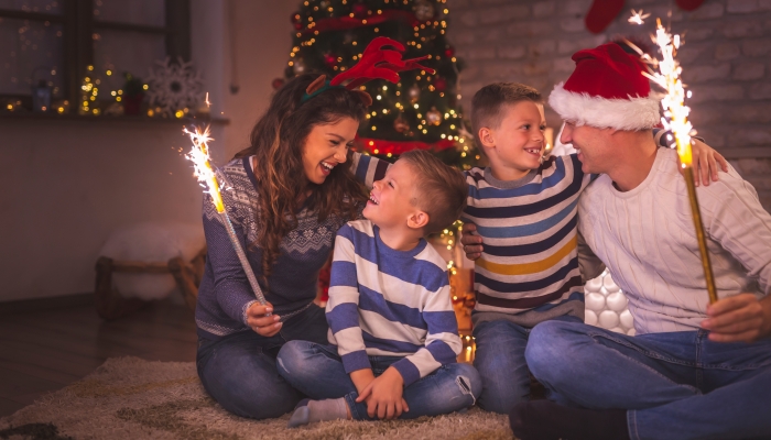 Beautiful happy family celebrating New Year at home.