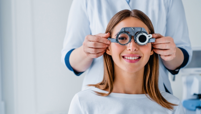 Female patient checking vision in ophthalmological clinic.