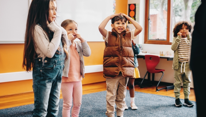 Kids sing and move along to an educational rhyme in class.