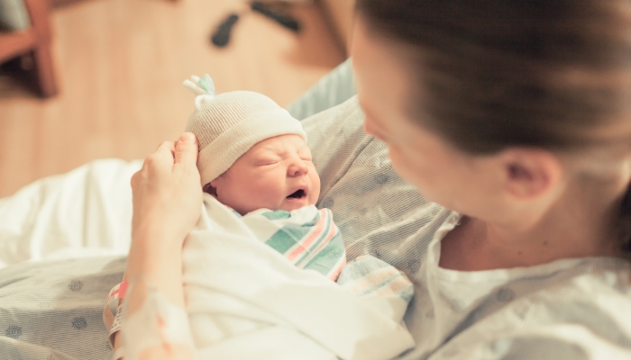 Mother holding her new born baby boy.