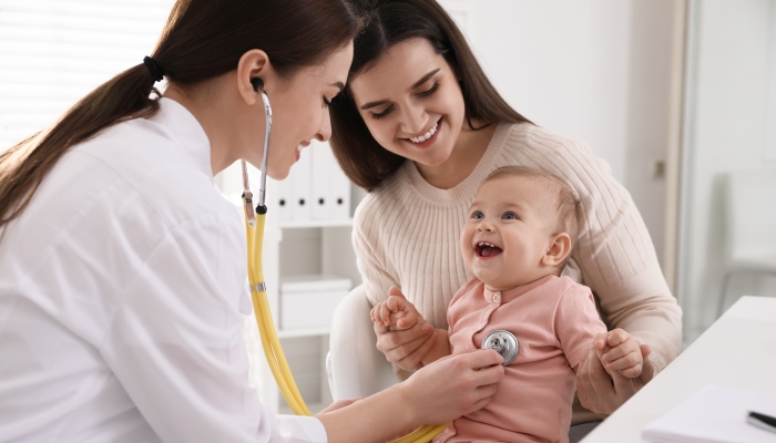 Mother with her cute baby visiting pediatrician in clinic.