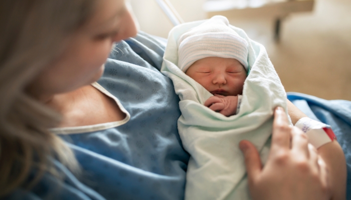 Mother with her newborn baby at the hospital a day after a natural birth labor.