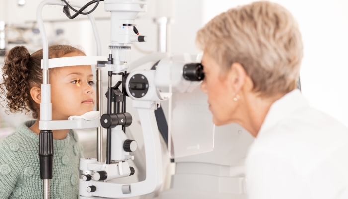 Optometry, vision and optometrist doing eye test on girl for optical care.