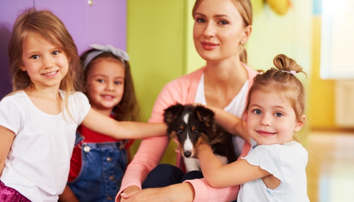 Preschool children having fun with dog.