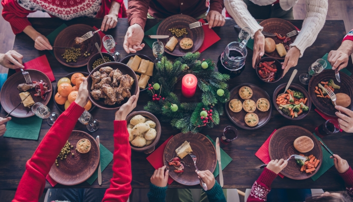 Top view photo family sitting at festive table.