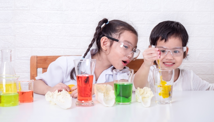 Two little Asian cute girl role playing a scientist.