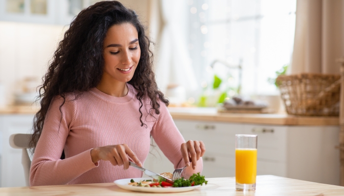 Beautiful Brunette Woman Eating Tasty Breakfast.