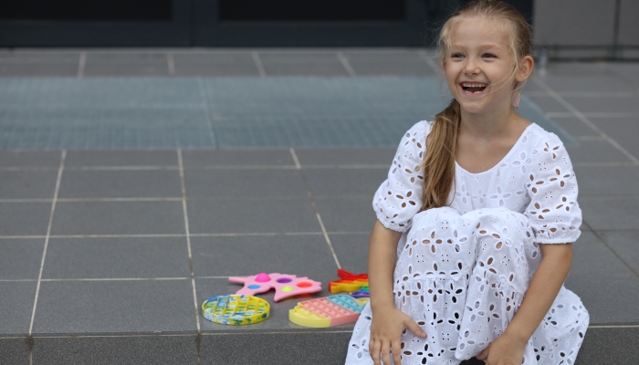 Beautiful girl playing with fidget Pop It.