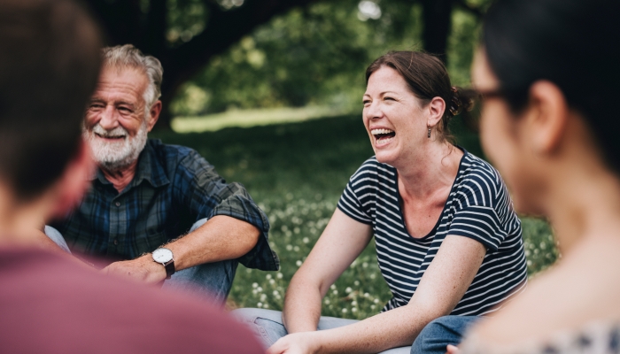 Cheerful woman in the park with her friends.