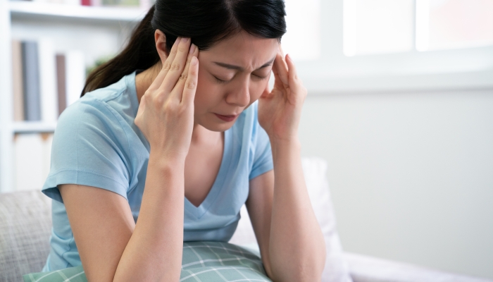 Japanese mom woman suffering from headache.
