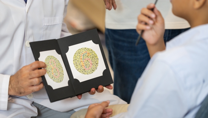 Optometrist doing color blindness disease perception test in optical shop.