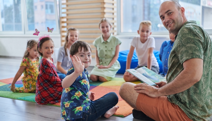 Reading time in an elementary school or kindergarten, a teacher reading a book to children in an elementary school or kindergarten.