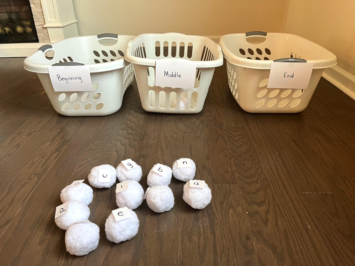 CVC word snowball toss game set up with laundry baskets.