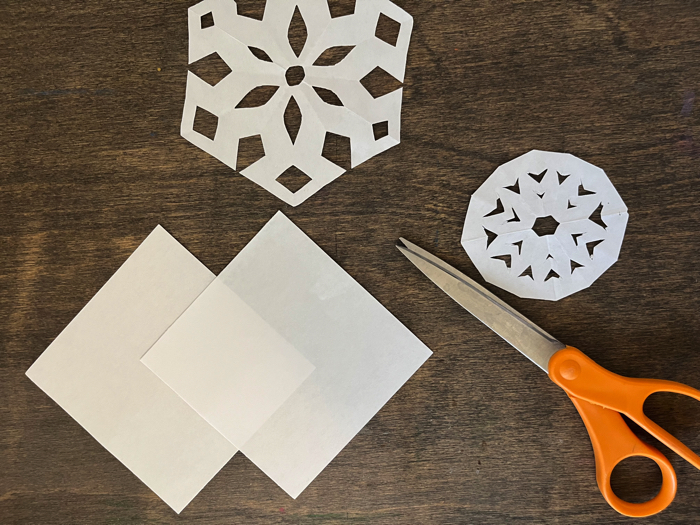 Folding hanging paper snowflakes.