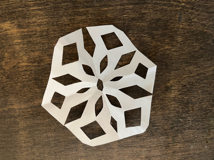 Folding hanging paper snowflakes.