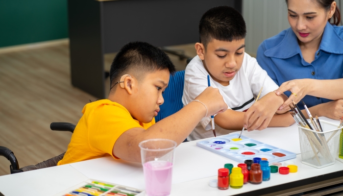 Asian disability child boy and Autism kid learning drawing in classroom.