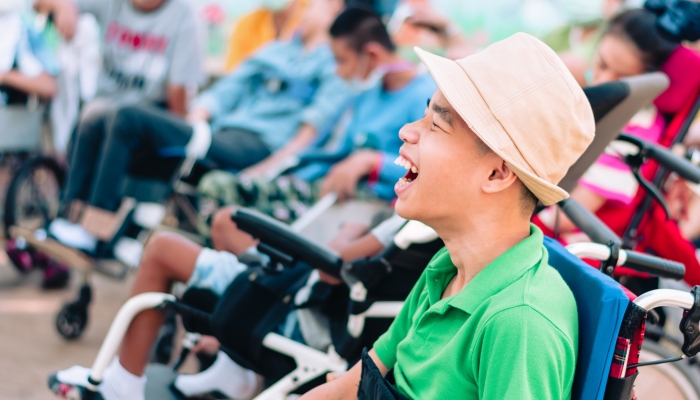 Asian disabled child on wheelchair is playing.