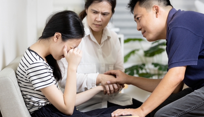 Asian parents give advice,talk sharing thoughts care to teenage girl.