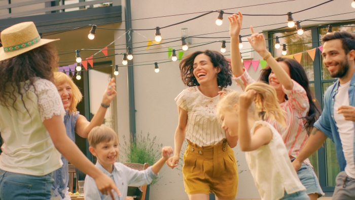 Family and Friends Dancing together at the Garden Party Celebration.