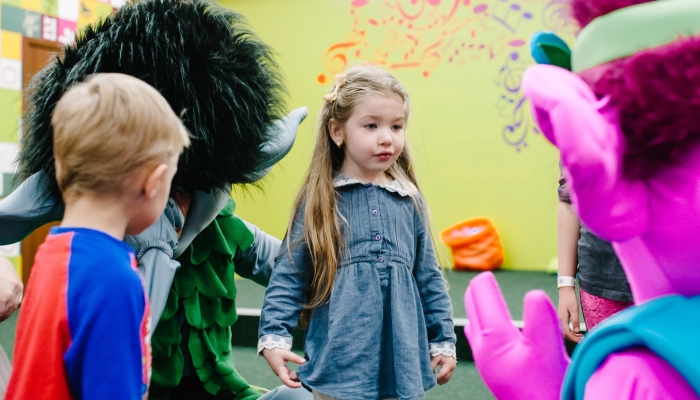 Happy little girls, boys 3-4 years, children playing in the game childrens room for birthday.