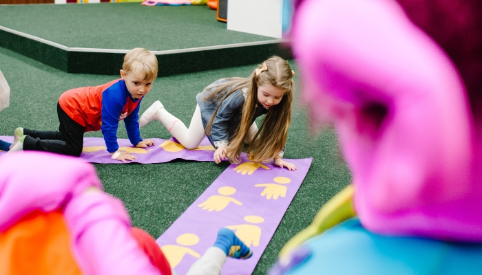 Happy little girls, boys, children playing in the game childrens room for birthday party. entertainment centre.