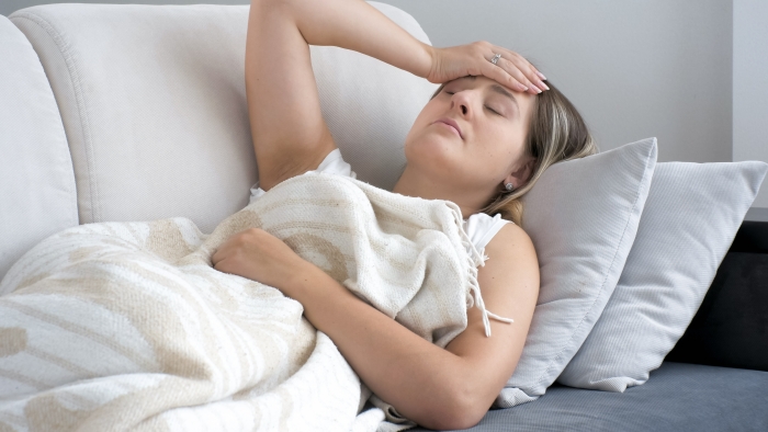 Portrait of brunette woman suffering from head ache.