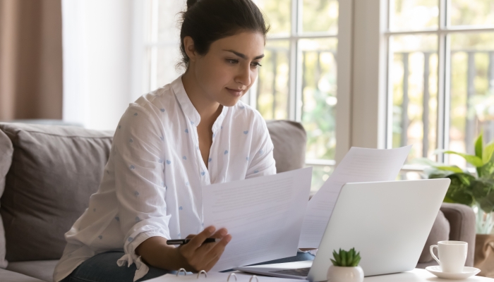 Serious Indian mother reviewing insurance documents.