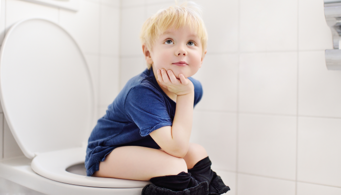 Toddler child is training use toilet.