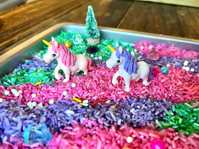 Playing with unicorn sensory rice.