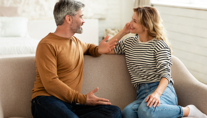 Cheerful Middle Aged Couple Talking And Flirting Enjoying Conversation.