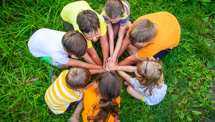 Children are playing with their hands clasped together.