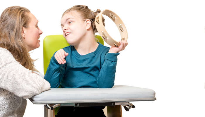 Disabled child in a wheelchair having music therapy.