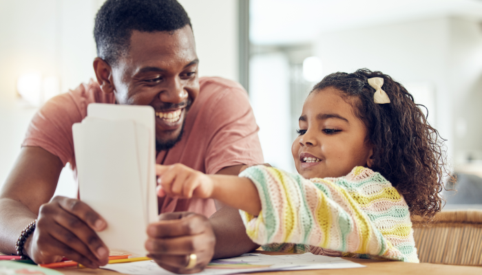 Home school, learning and father helping his child with flash cards, homework or studying.
