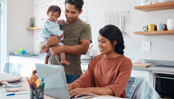 Internet, family and parents doing research on down syndrome with baby on a laptop in their house.